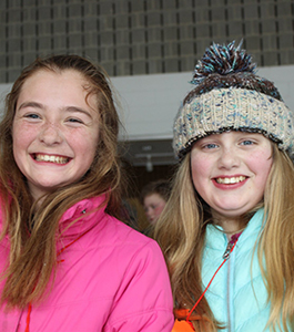 Two girls smiling while playing in the snow