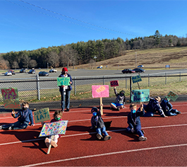 First graders outside with signs