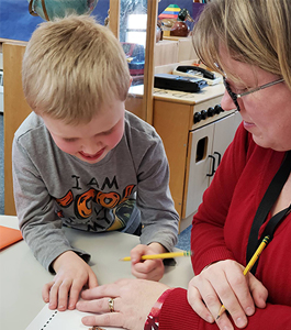 Teacher working with Student on Classwork